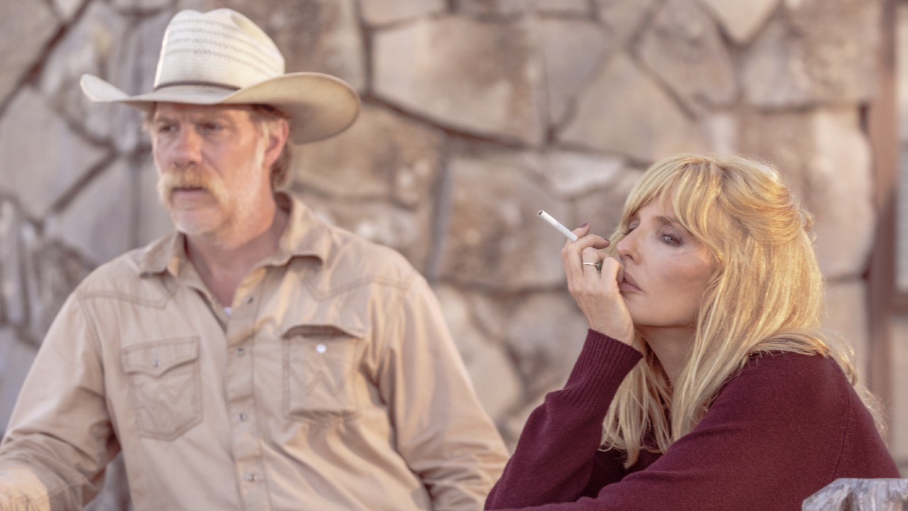 (L-R): Marc Menchaca as Zachariah and Kelly Reilly holding a cigarette in her left hand as Beth Dutton in Dutton Ranch. 