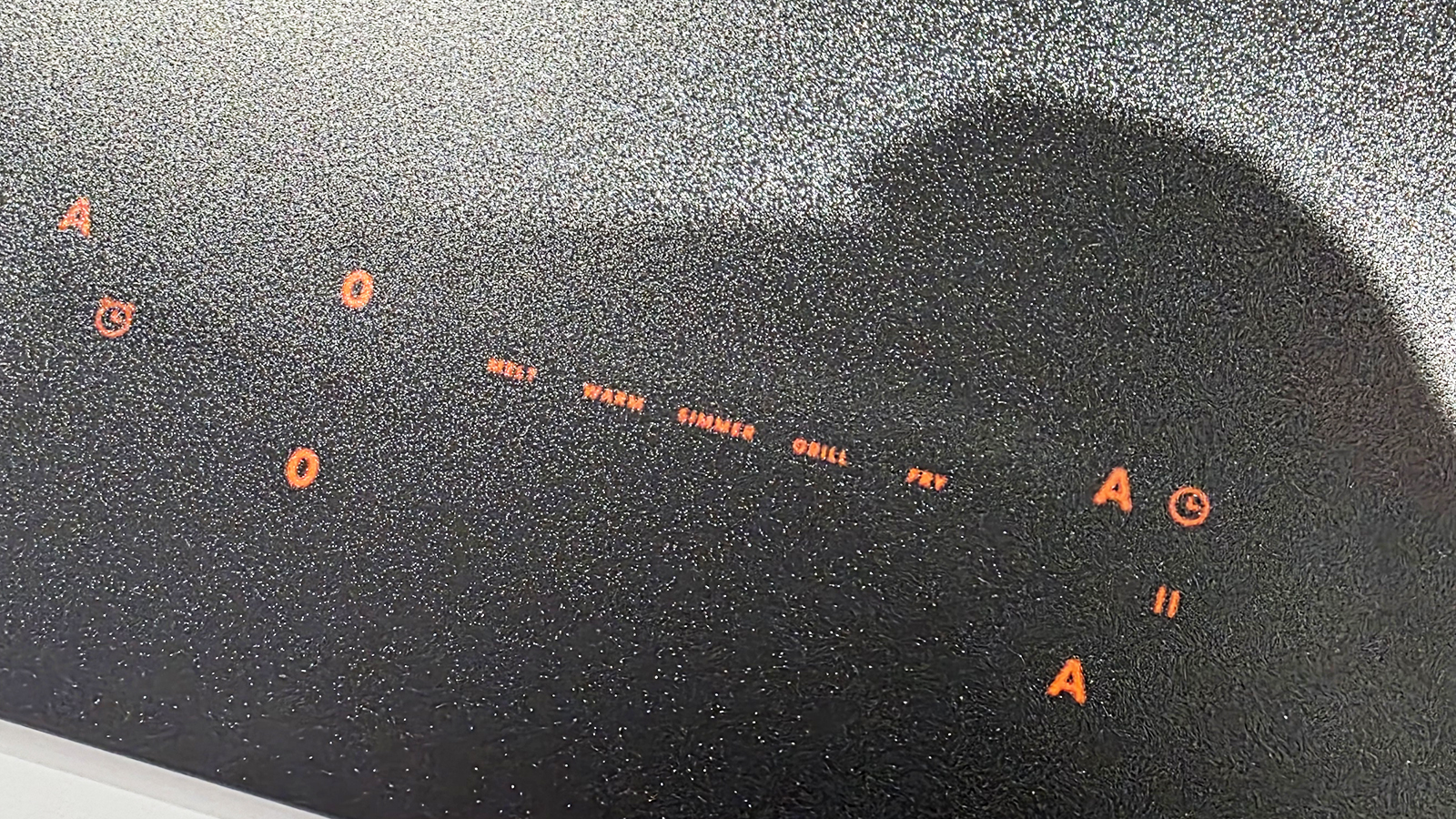 A black induction cooktop from Hisense on a kitchen countertop