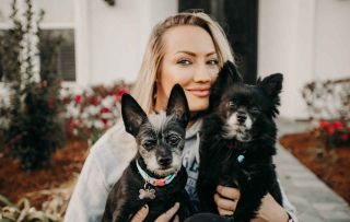 Nita Strauss holding her dogs Bentley and Motley and