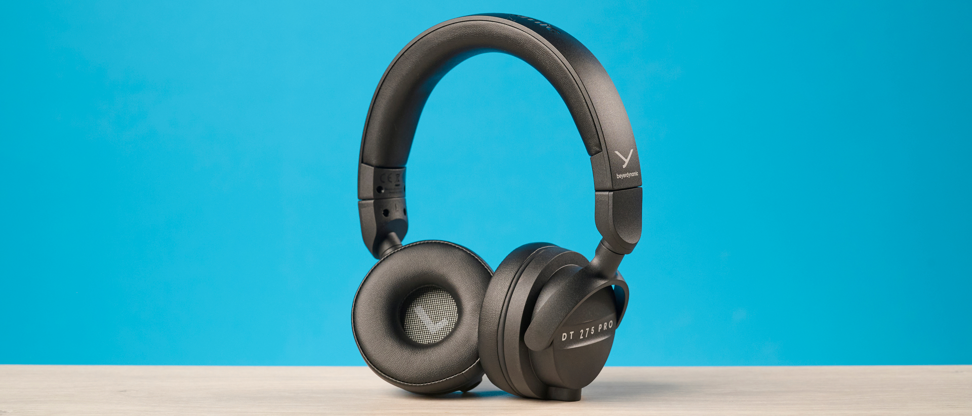 Beyerdynamic DT 275 Pro photographed in front of a blue background