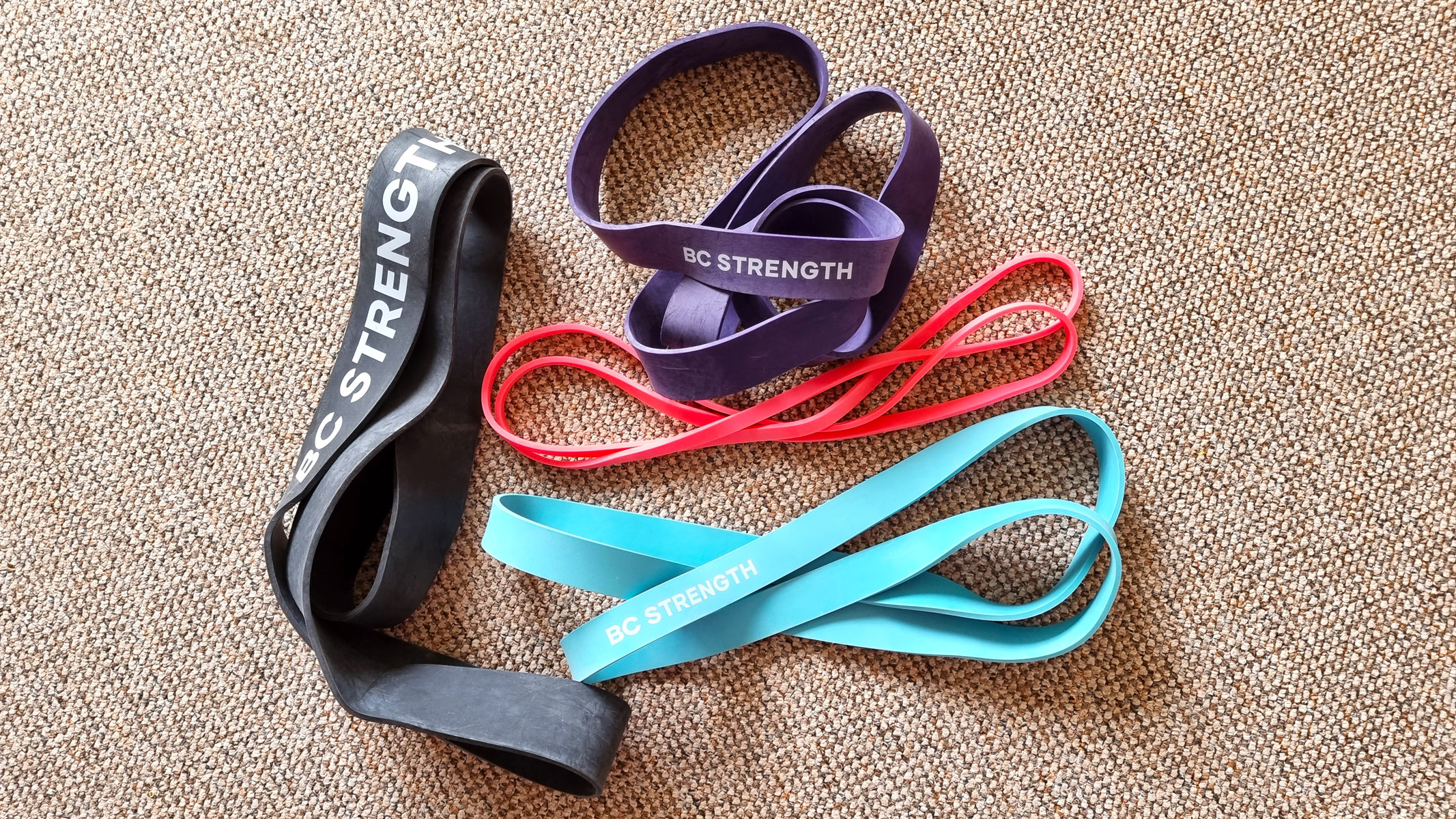 BC Strength resistance band set laid out on the floor