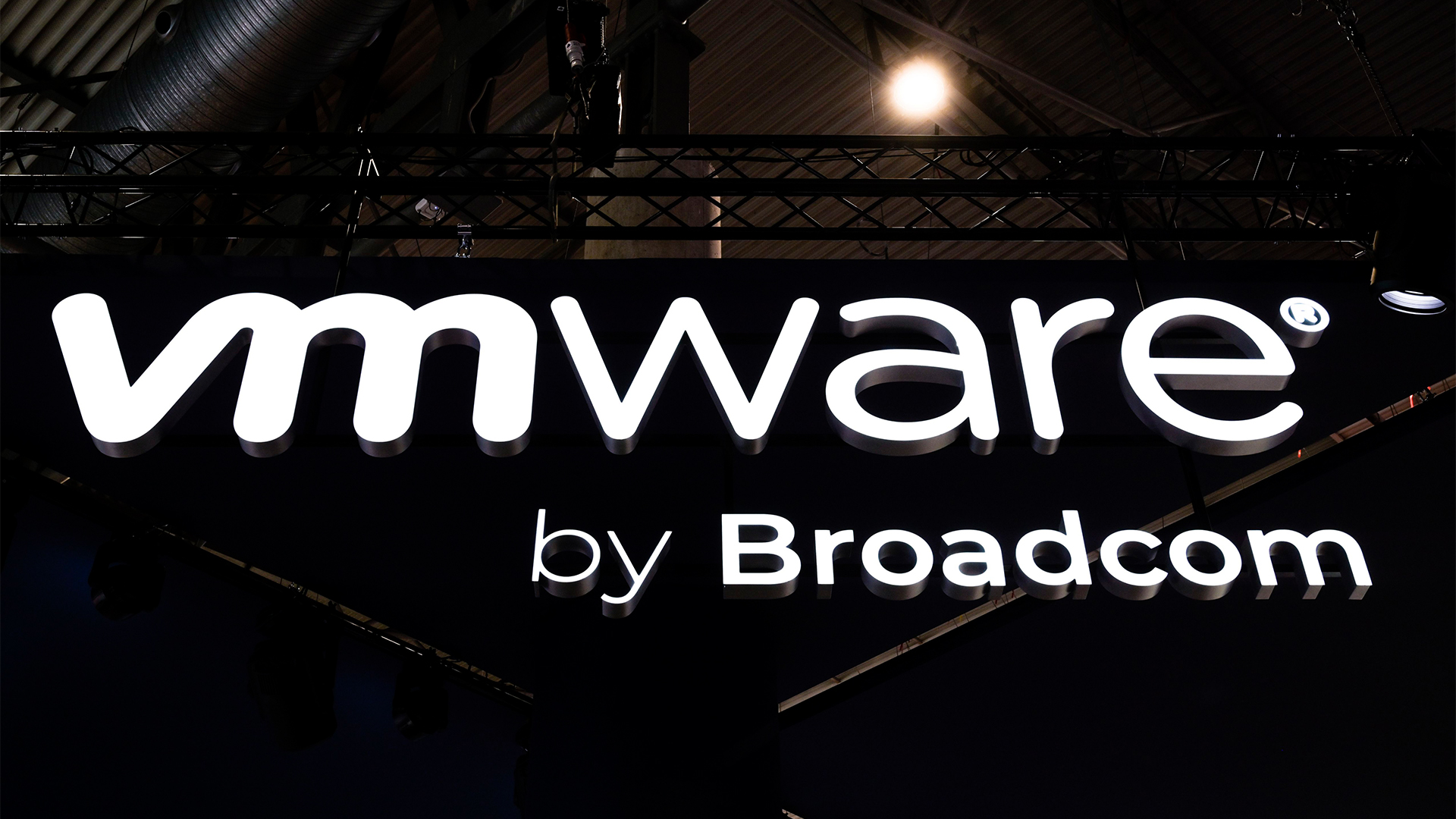VMware by Broadcom branding in luminous white lettering against a black background, pictured at the company's vendor stall at Mobile World Congress (MWC) 2024 in Barcelona, Spain.