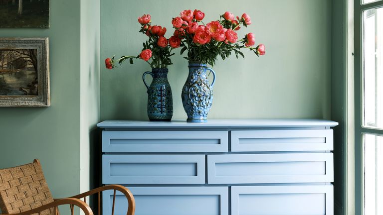 Green painted room with blue upcycled furniture and pink flowers