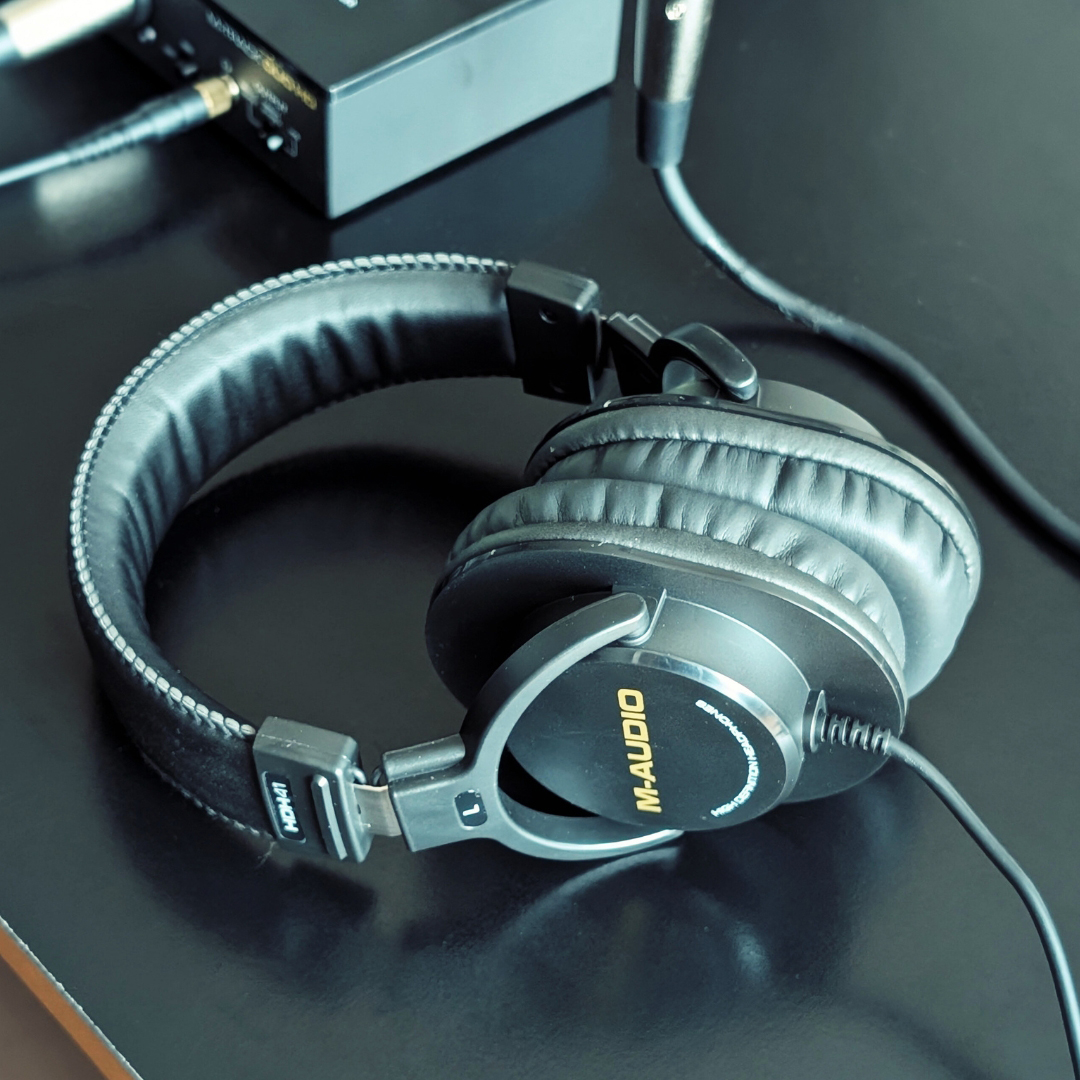 A pair of M-Audio headphones on a table