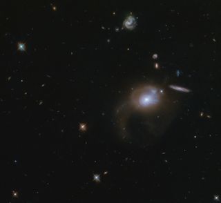 In this image taken by the Hubble Space Telescope, you can see the sparkling, sprawling wonder of space. Featured in this image is the galaxy SDSS J225506.80+005839.9. This galaxy with its long (not exactly catchy) name can be seen in the center right of this image. The recently discovered galaxy lies about 500 million light-years from Earth and is a perfect example of what can be discovered by space telescopes like Hubble.