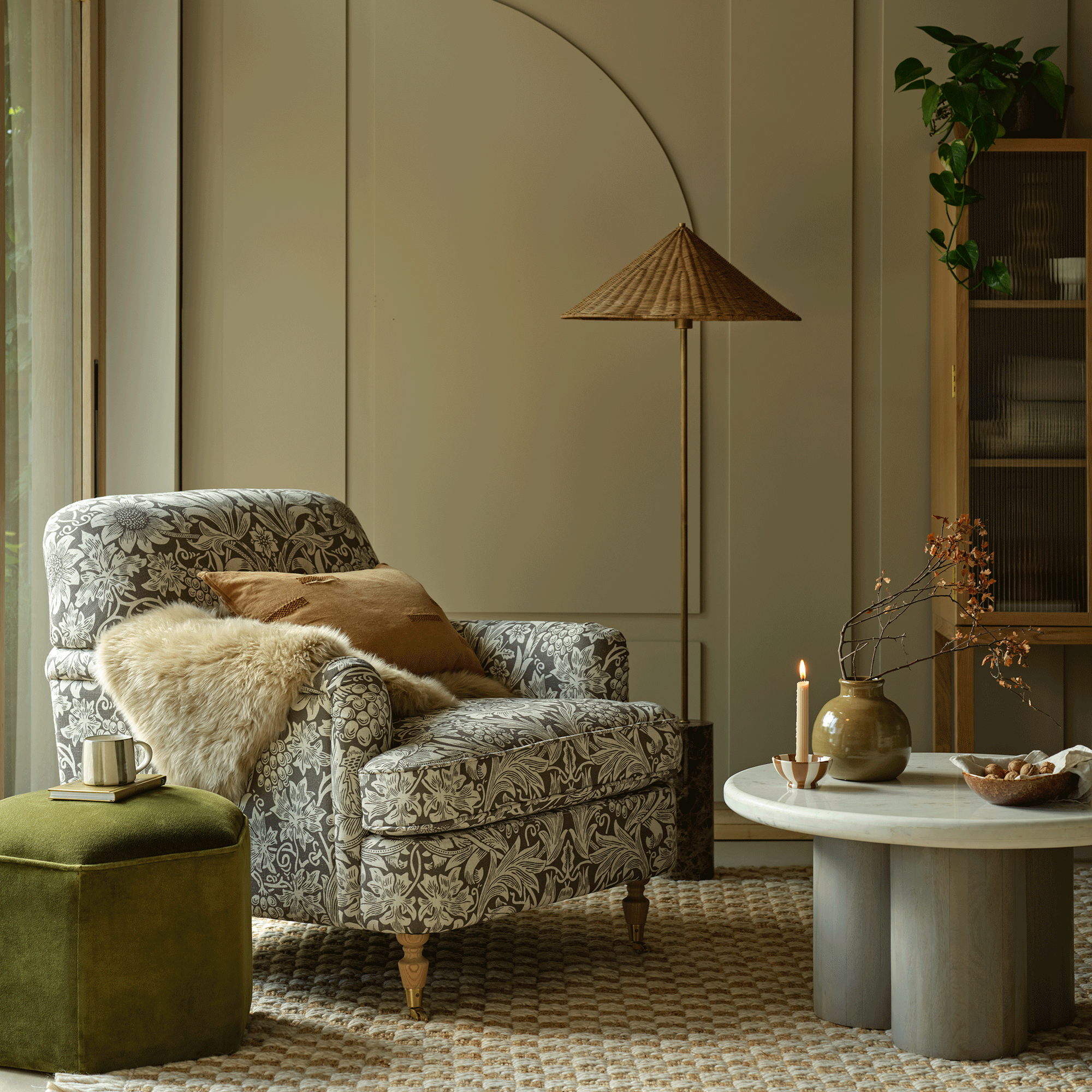 Beige living room with white and grey morris and co armchair and circular coffee table
