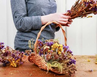 autumn floral arrangement in wicker basket using dried flowers