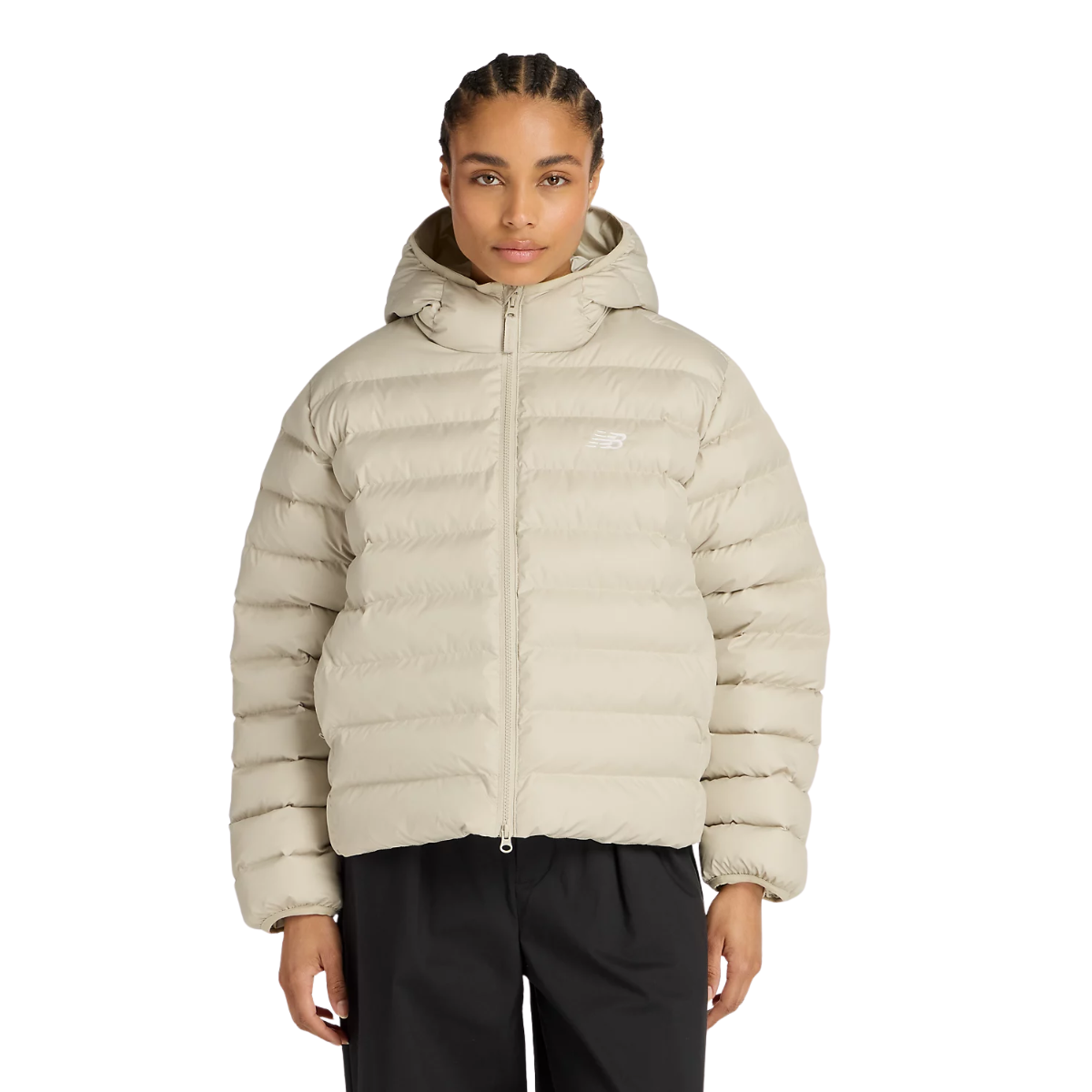 Model wearing black trousers and beige puffer jacket