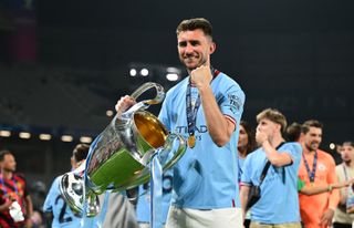 Aymeric Laporte celebrates with the Champions League trophy after Manchester City's win in the final against Inter in June 2023.