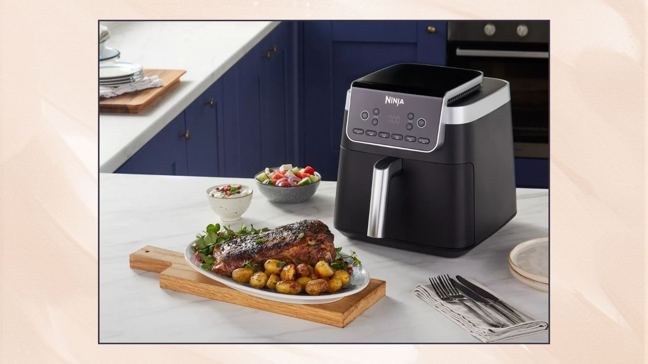 Ninja Air Fryer MAX PRO 6.2L in a blue kitchen next to a leg of lamb