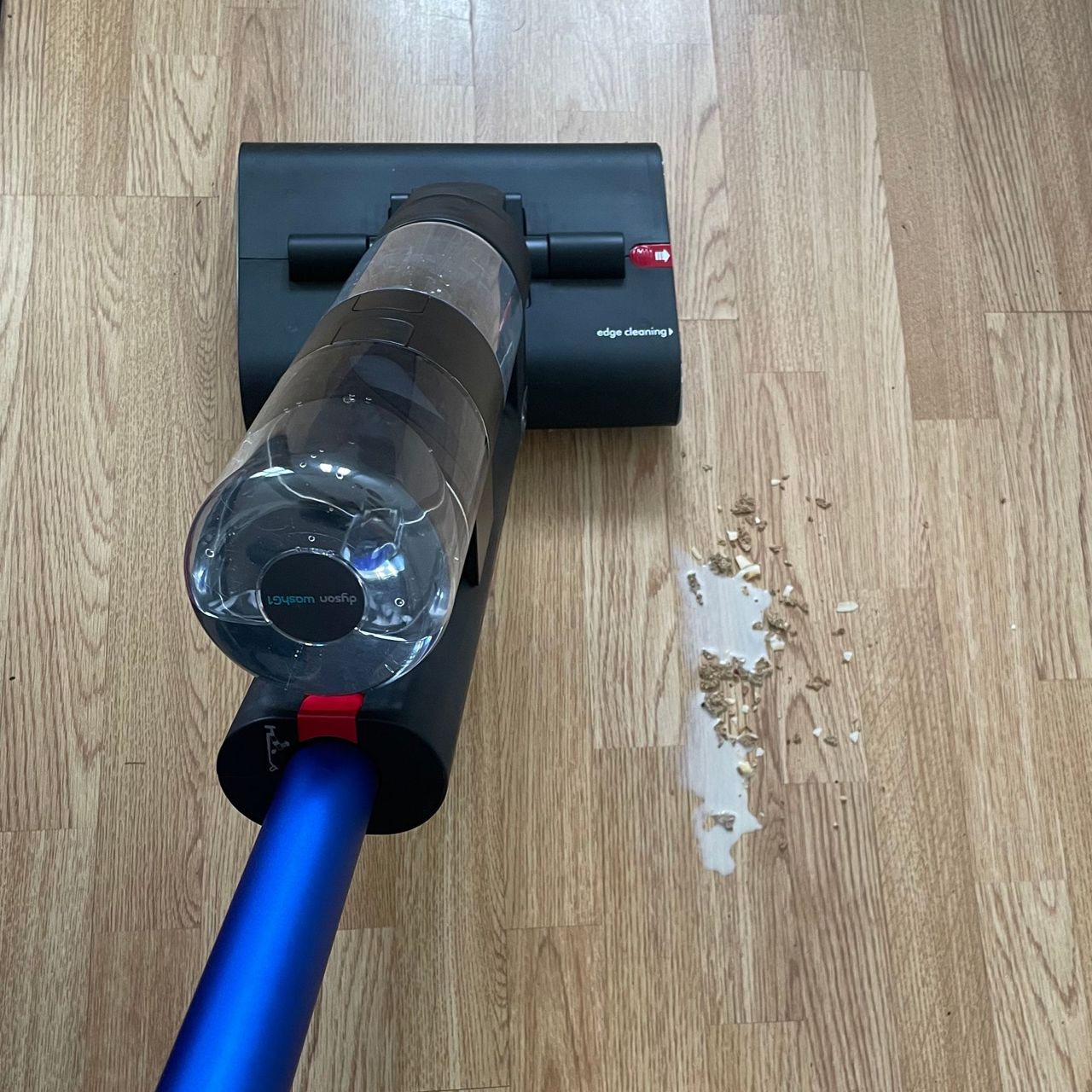 Dyson WashG1 picking up milk and muesli off hard flooring