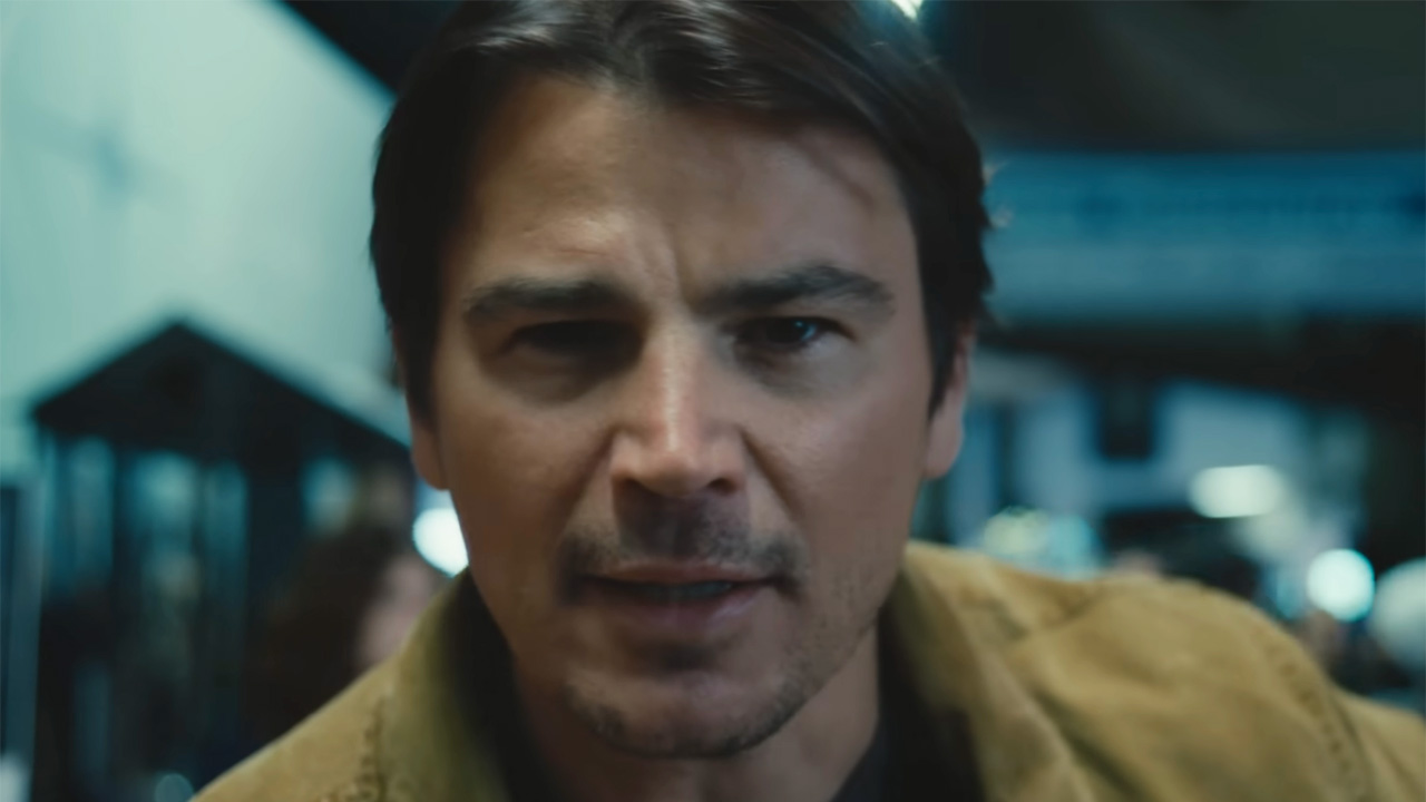 Josh Hartnett staring at the camera in tense scene at the stadium in Trap. 