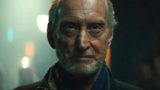 Charles Dance looks ahead with an evil smile in Godzilla: King of the Monsters.