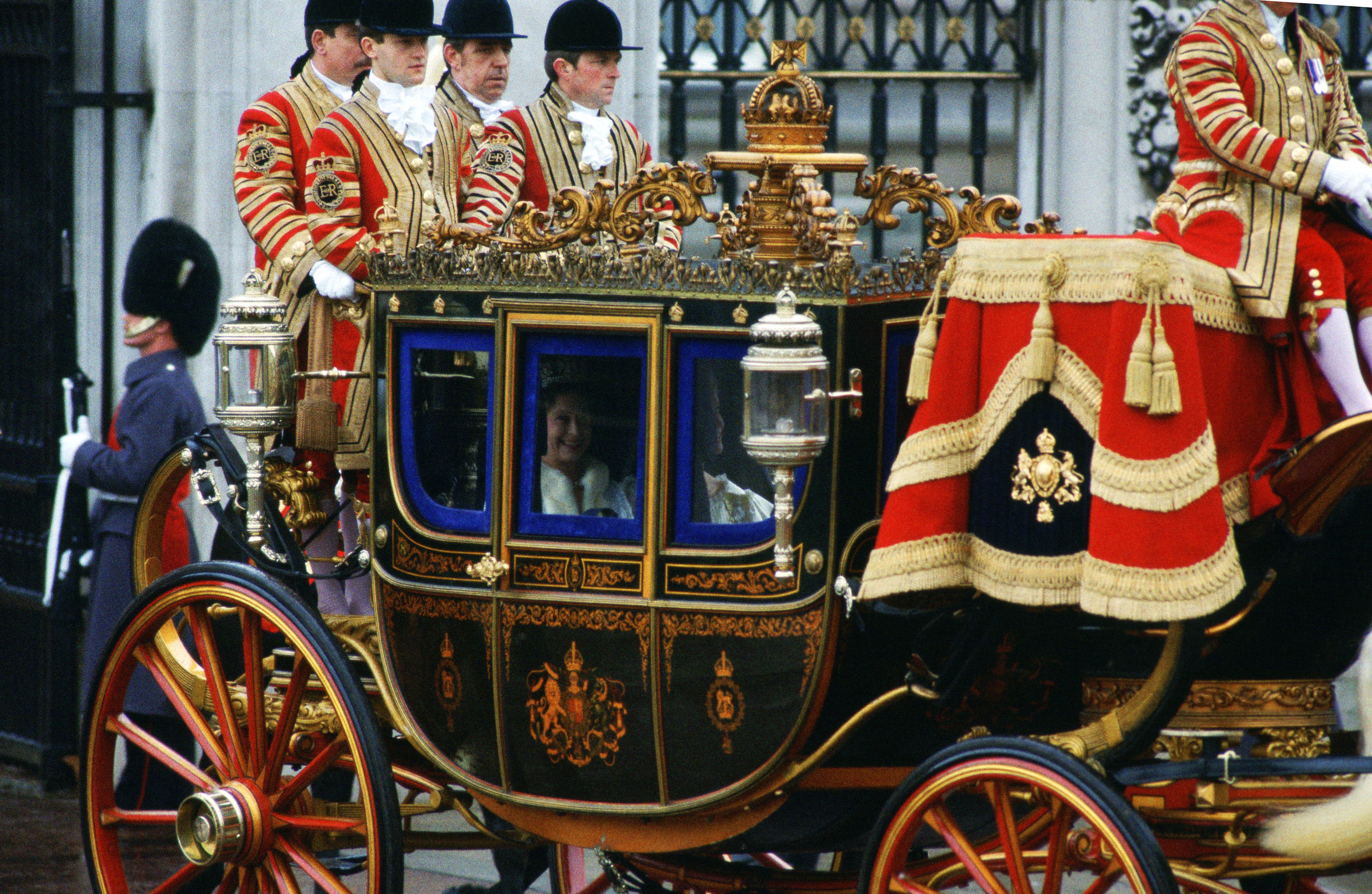 Queen Elizabeth riding in a glass carriage