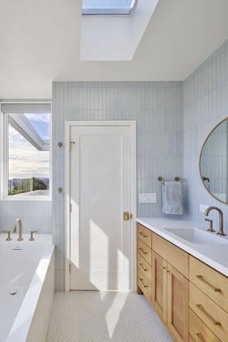 Bathroom with skylight at The Fourth Wall house by SAW