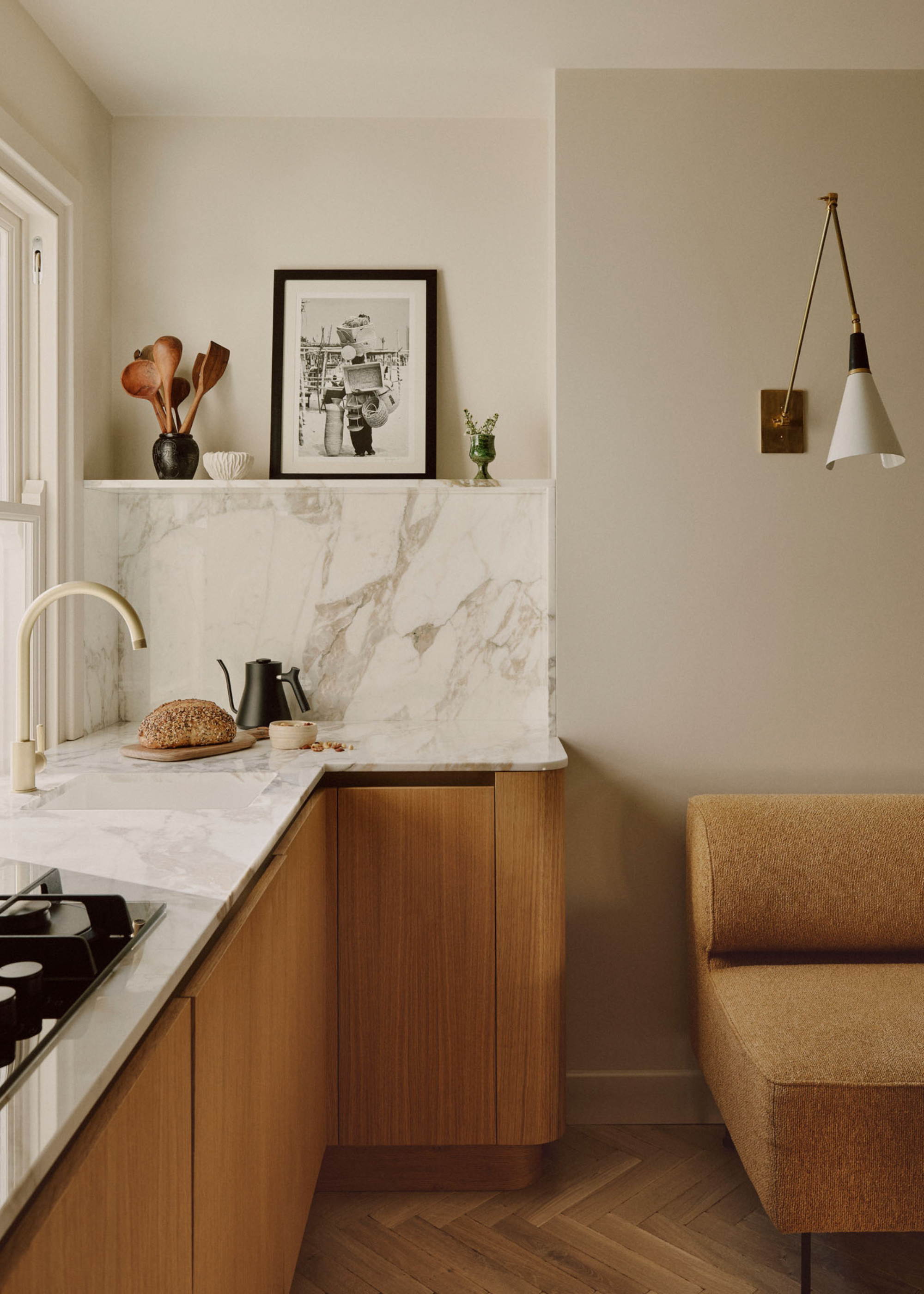 A kitchen with a vase holding wood spoons