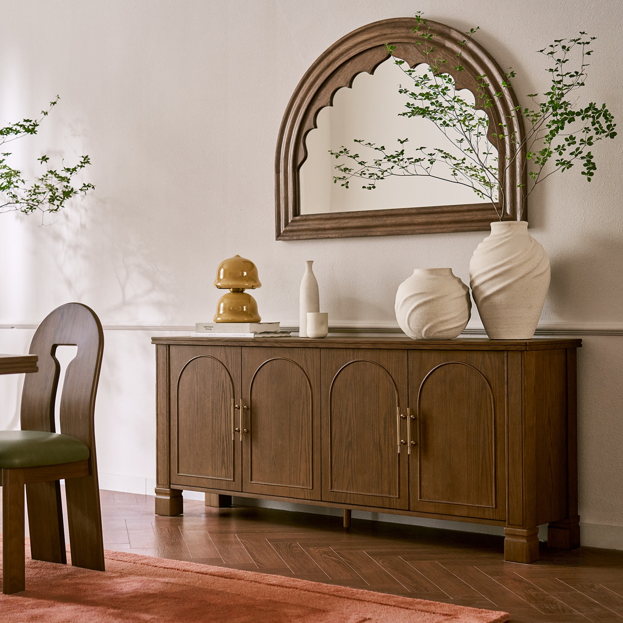 The Rava sideboard from Tan France's collection for Castlery in a dining room with a mirror hanging above it