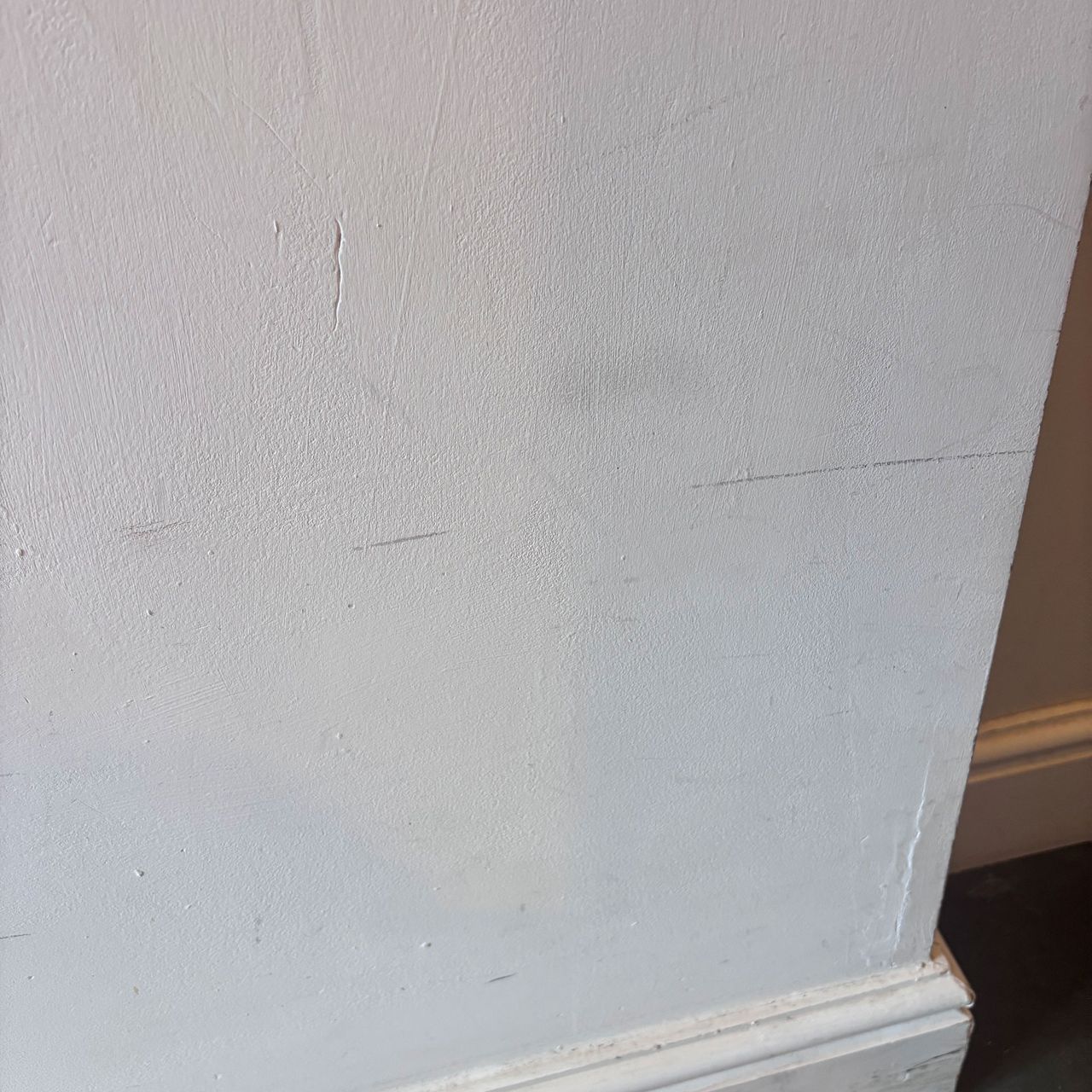corner of a white wall with scrapes and scuffs