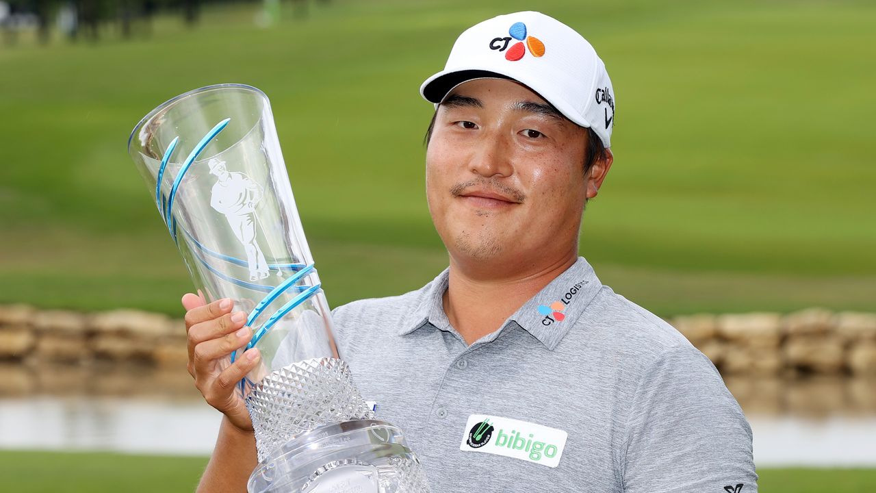 K H Lee holds the AT&amp;T Byron Nelson trophy