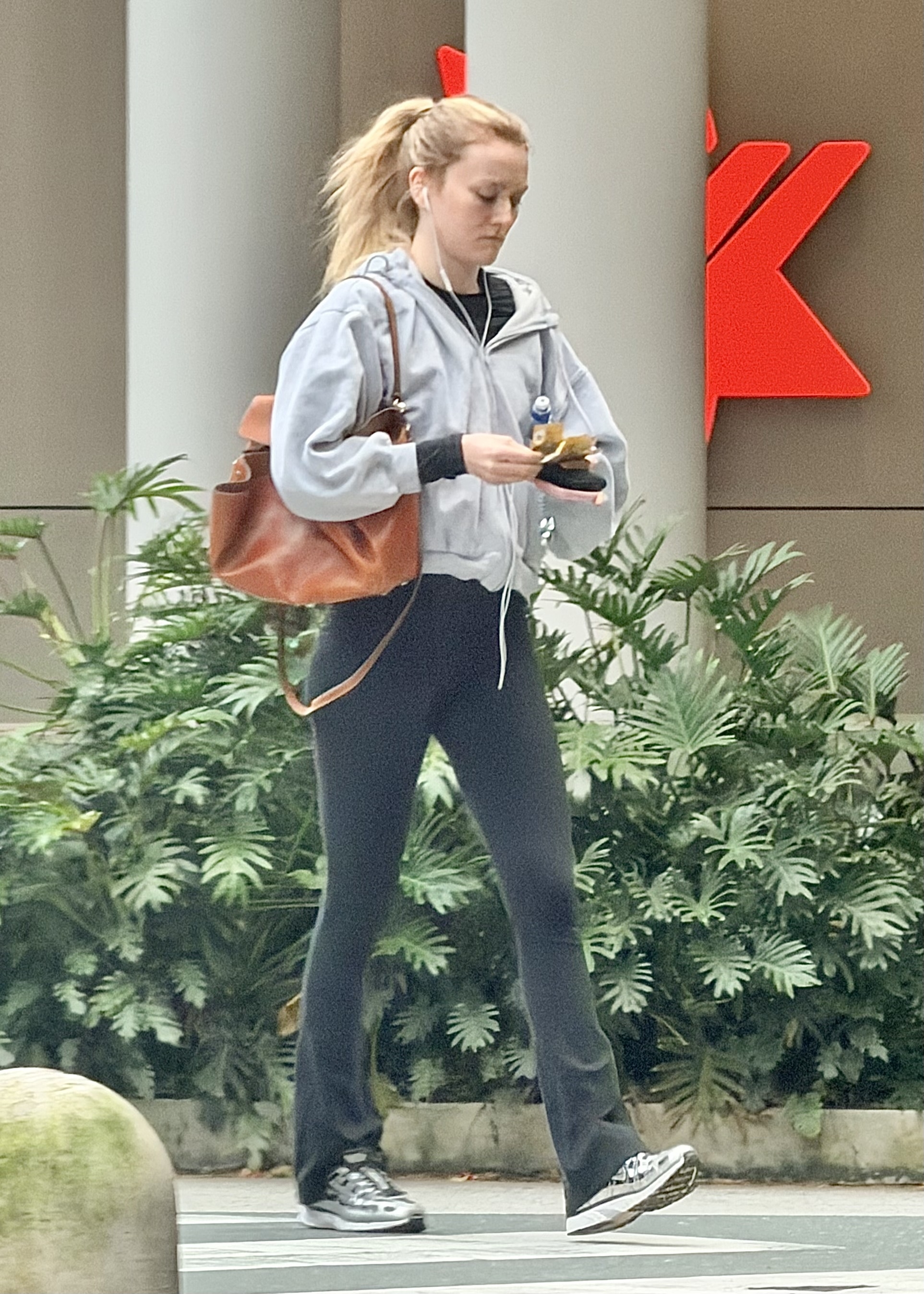 Sarah Pidgeon wearing flared leggings and Nike sneakers in Brisbane