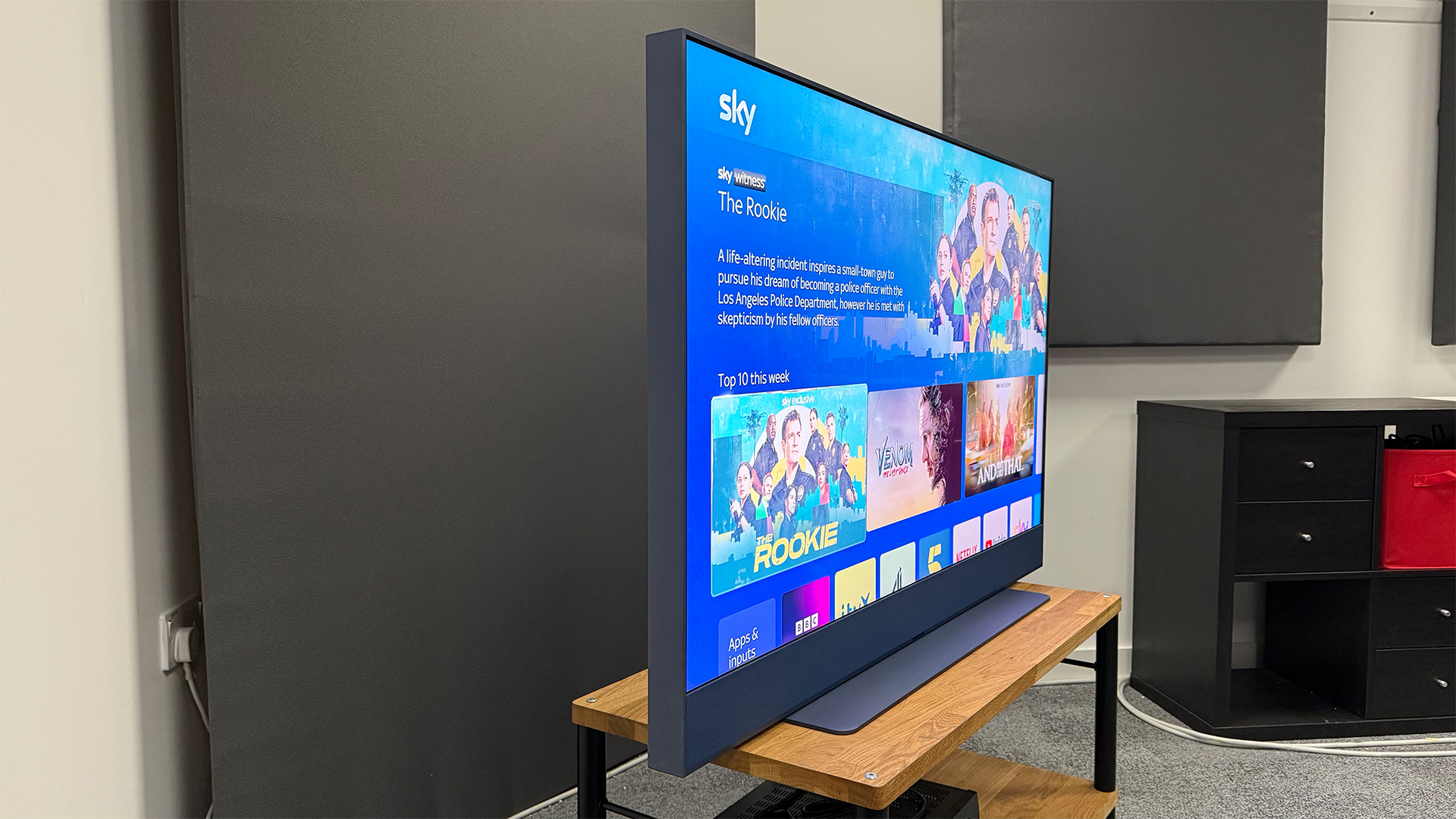 Sky Glass Gen 2 TV, soundbar and streaming service on wooden AV rack, side on view