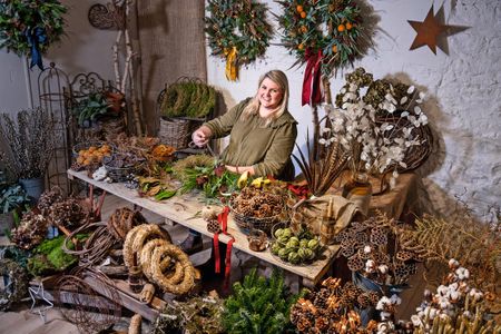 Amid a cornucopia of wreath-making materials, Ellie Taylor works her magic.