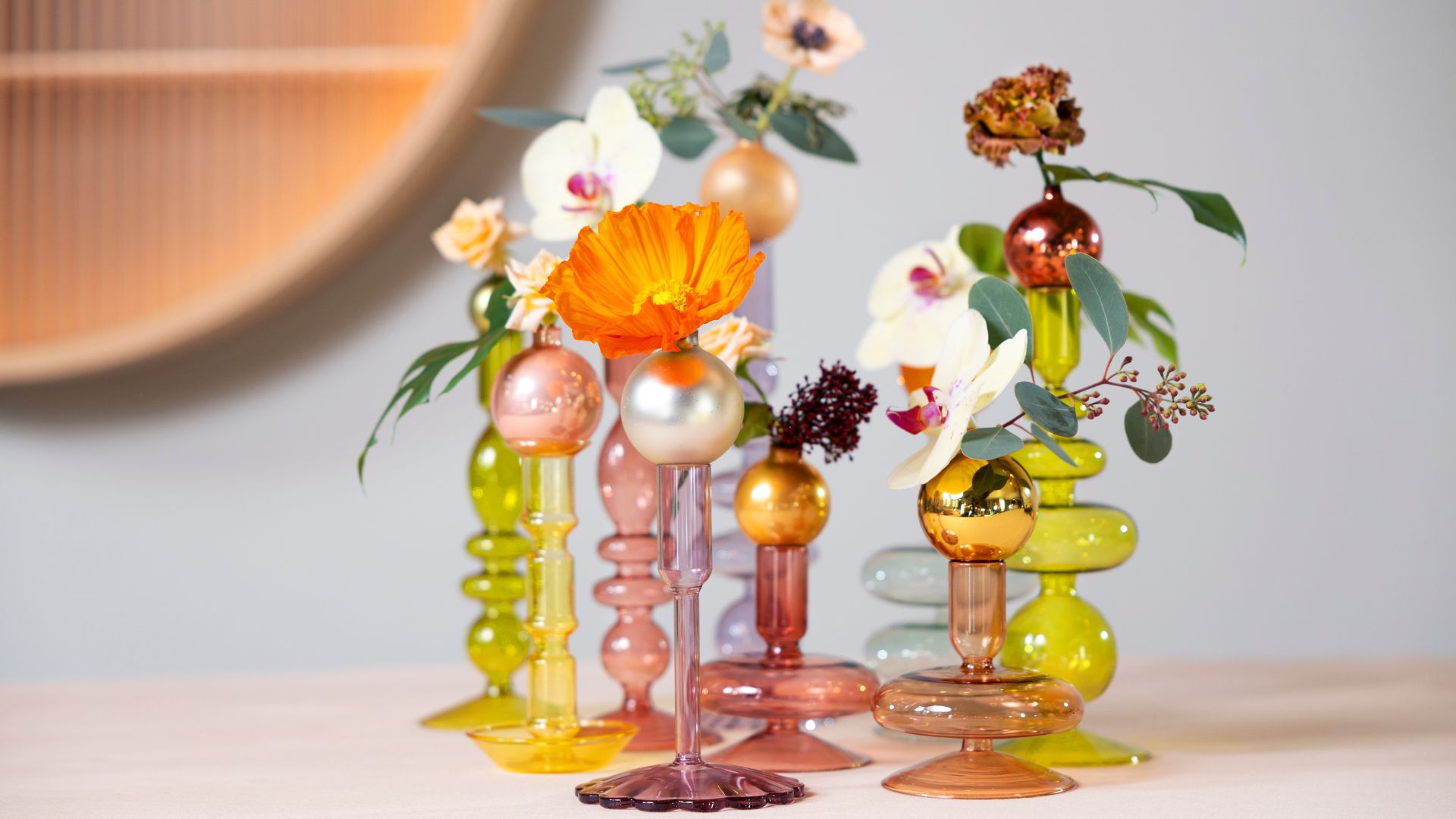 A set of mini vases with cut flowers like orchids and roses