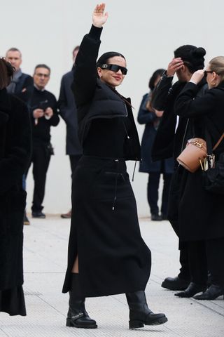 Rosalia wearing an all-black look with moto boots to Dior