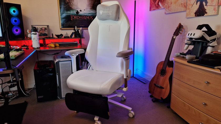 A white Secretlab Titan Evo NanoGen Edition in front of a gaming setup