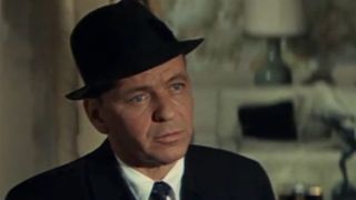 A close up of Frank Sinatra in a suit and wearing a fedora in The Detective
