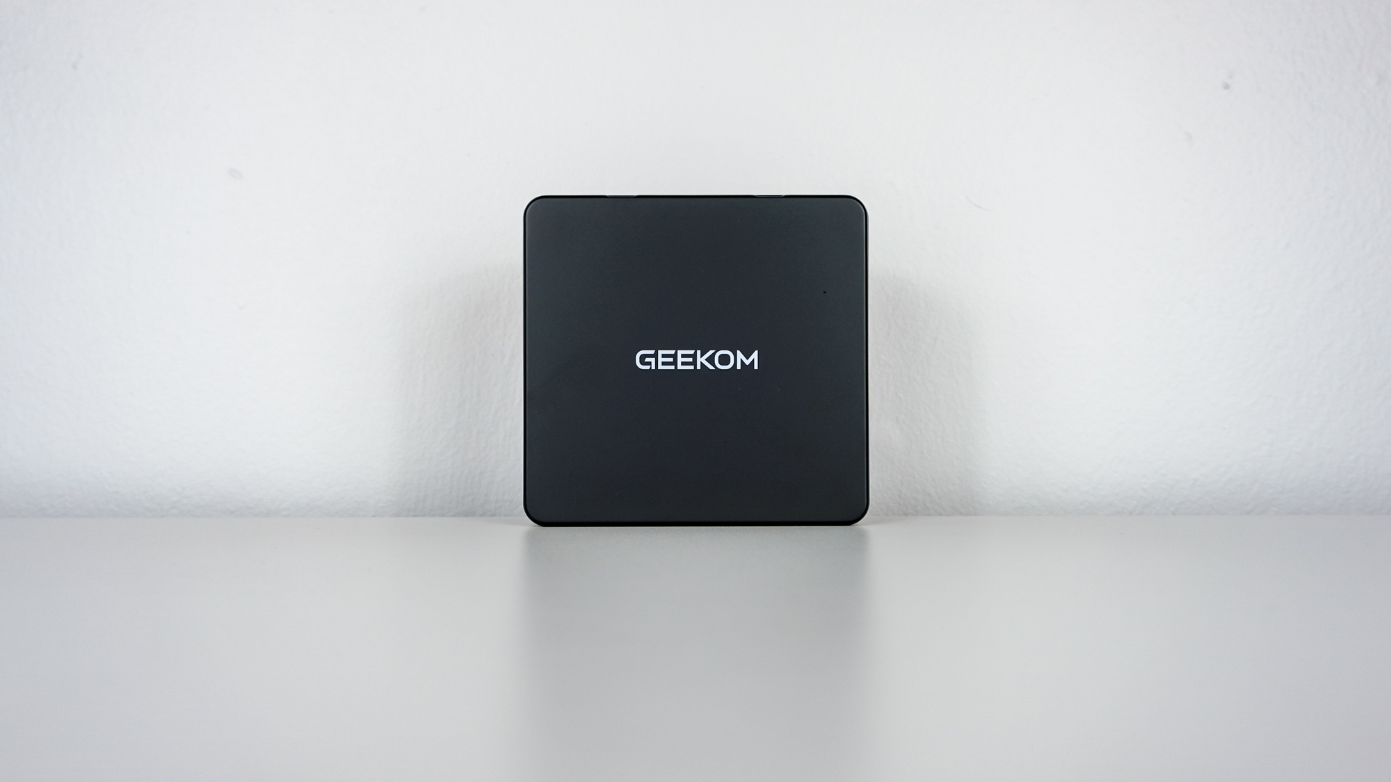 The Geekom IT15 mini PC upright on a desk