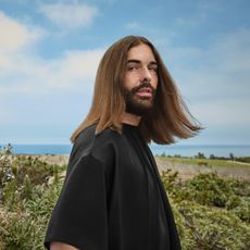 jonathan van ness with good hair in a field
