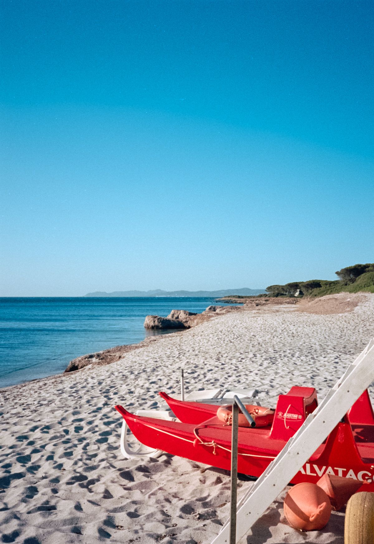 Sunny beach with a lifeguard station in the foreground