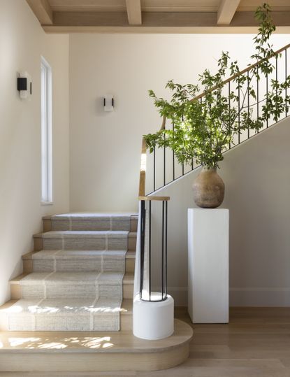 wooden staircase with neutral stair runner by Ryan Street