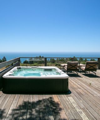 hot tub on a deck overlooking the ocean