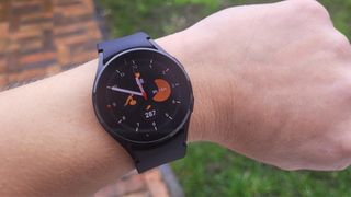 The Samsung Galaxy Watch4 being worn outside in the rain