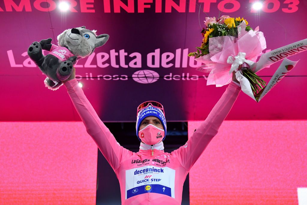 CESENATICO ITALY OCTOBER 15 Podium Joao Almeida of Portugal and Team Deceuninck QuickStep Pink Leader Jersey Celebration Flowers Mascot Mask Covid safety measures during the 103rd Giro dItalia 2020 Stage Twelve a 204km stage from Cesenatico to Cesenatico girodiitalia Giro on October 15 2020 in Cesenatico Italy Photo by Stuart FranklinGetty Images