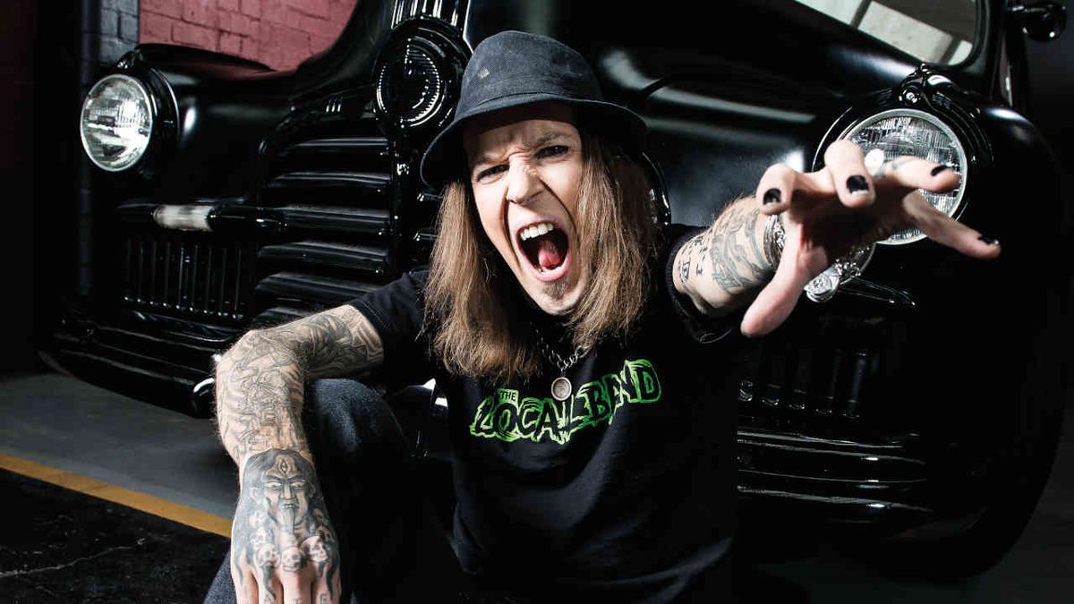  Children Of Bodom’s Alexi Laiho sitting in front of a vintage car