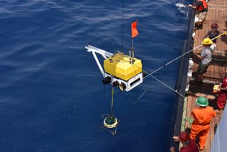 A seismometer being deployed into the ocean at the Mid-Atlantic Ridge.
