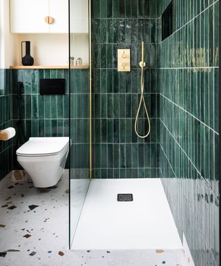 Small bathroom with fun Terrazzo floor tiles and green glazed tiles in shower area