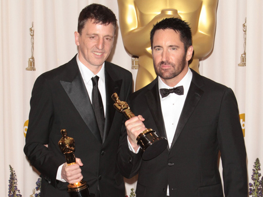 Atticus Ross (left) and Trent Reznor celebrate Oscar glory.