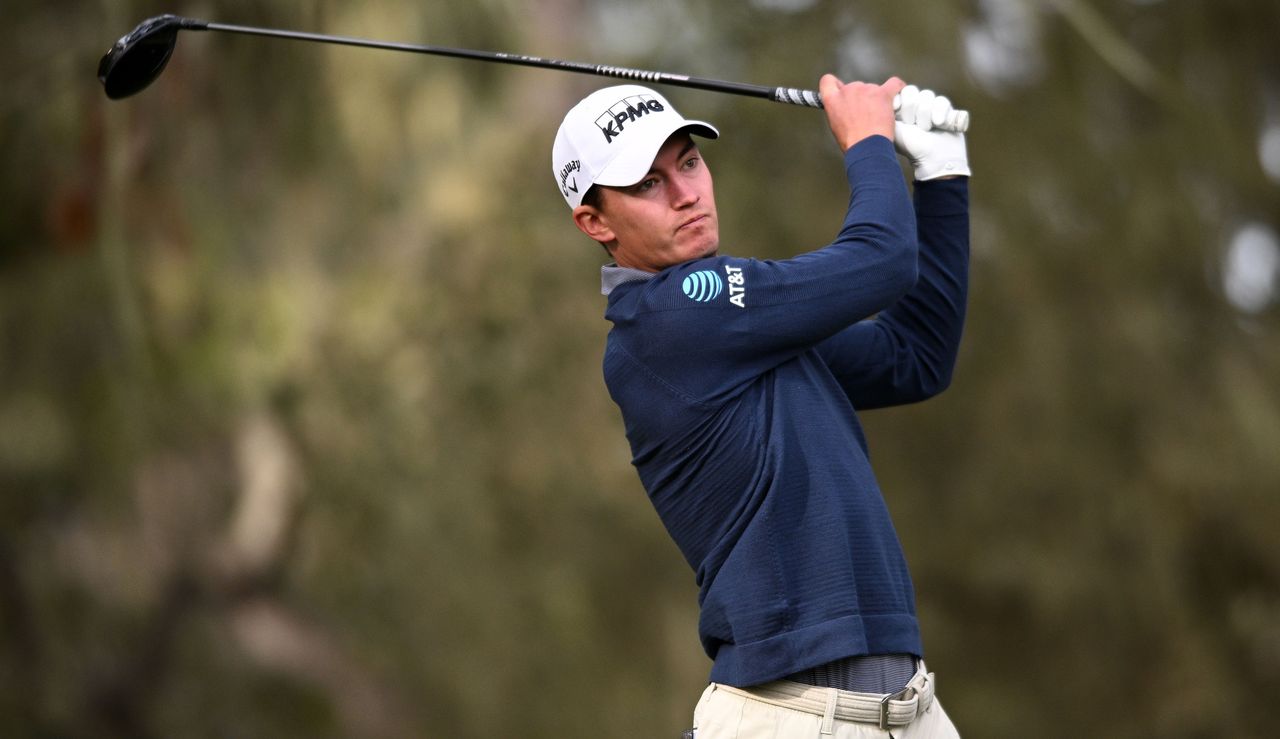 Maverick McNealy strikes his tee shot and watches it in the air