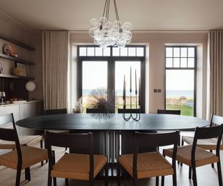 dining area with patio doors and side panel window looking out to sea view