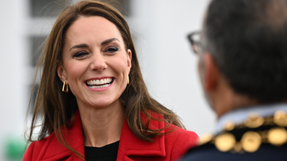 Kate Middleton wears red coat and gold earrings while visiting Royal National Lifeboat Institution