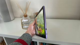 Amazon Fire HD 10 () tablet side angle in front of white shelf