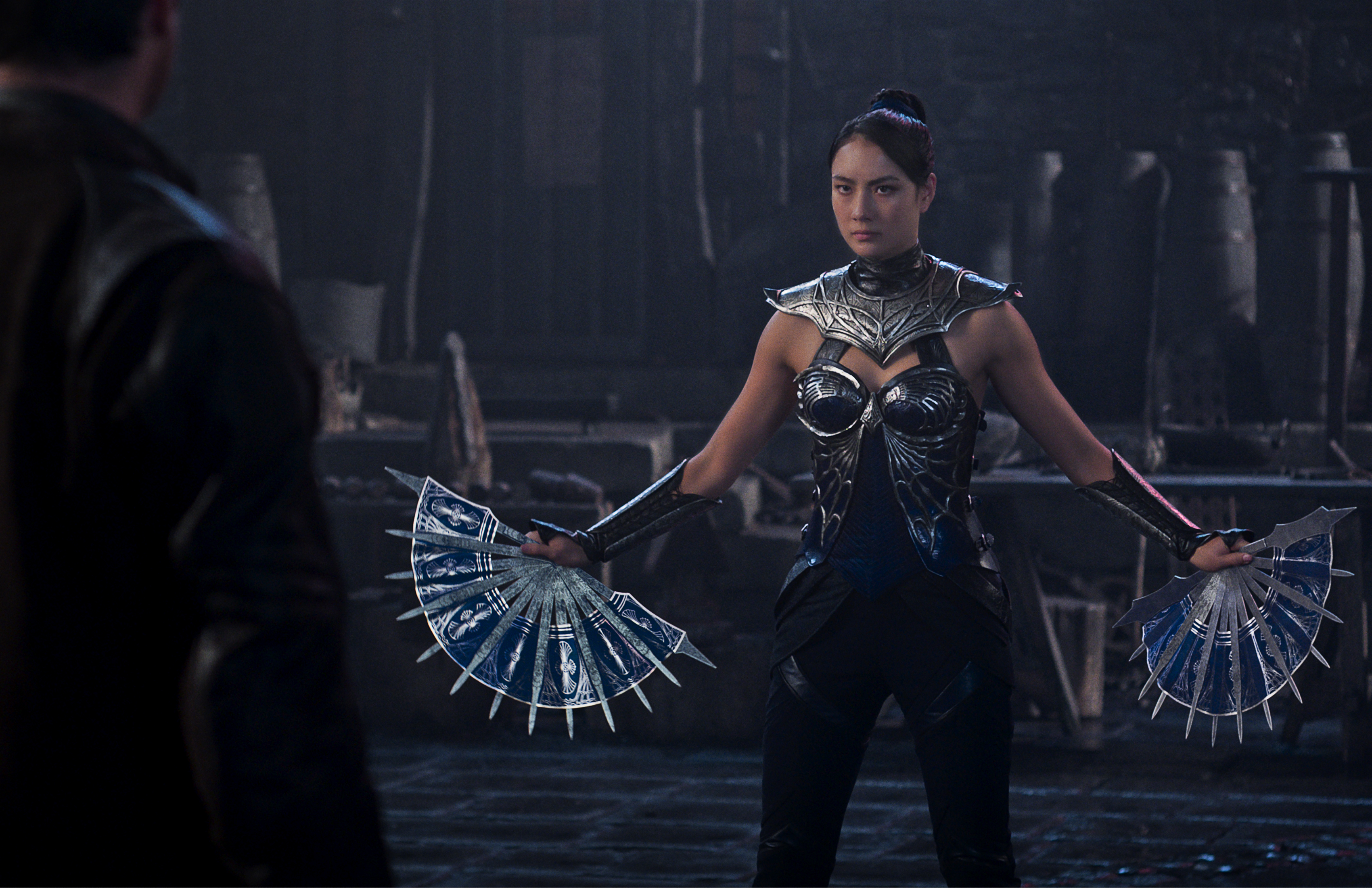 Adeline Rudolph as &amp;ldquo;Kitana&amp;rdquo; wearing a metal suit and holding fans that look like blades in a still from Mortal Kombat II