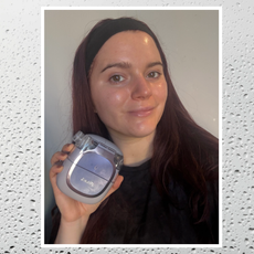 Brooke knappenberger holding up shark facialpro glow device with white border on background of water droplets 