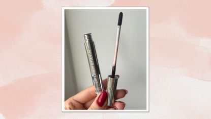 Image of hand holding the Sacheu Lip Liner Stain on a pink watercolour background