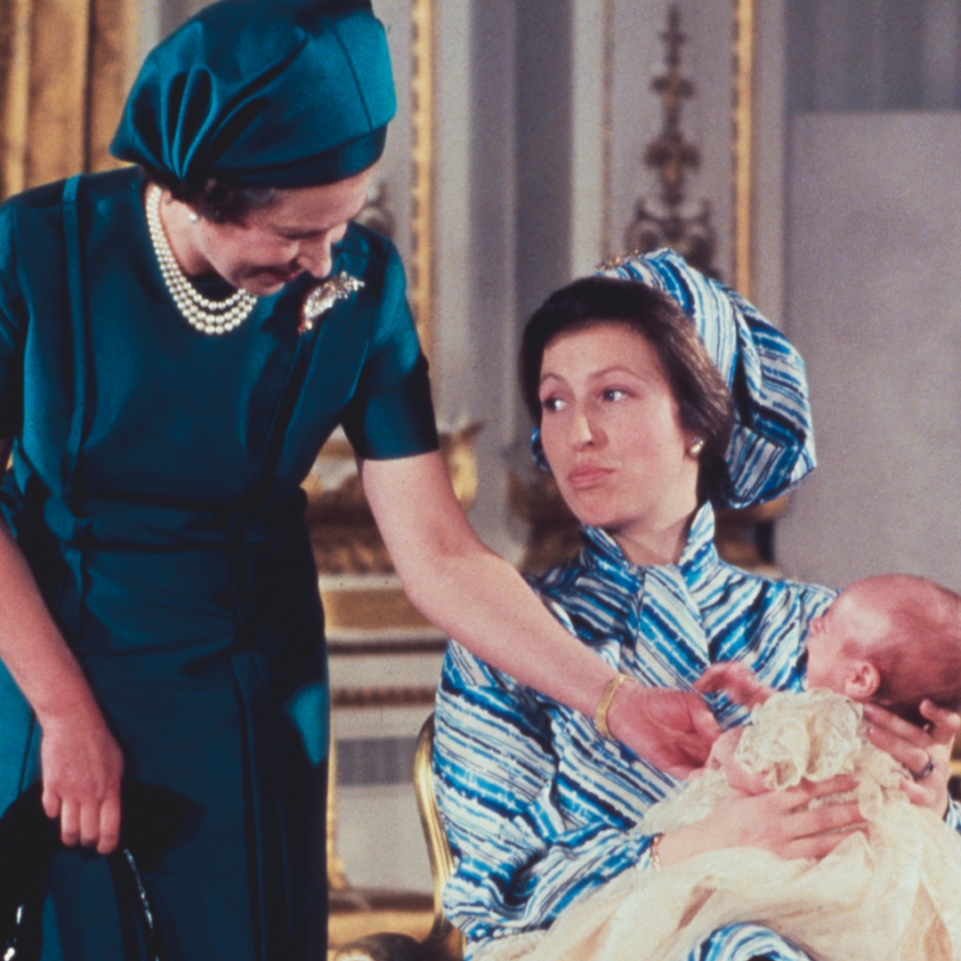 Queen Elizabeth smiling at baby Peter Phillips being held by Princess Anne 