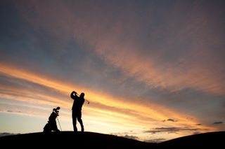 Solo golfer sunset